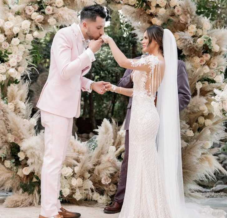 Picture of Andrea Espada and Ali Ferran Marrying holding hands in beautiful white marriage dress.